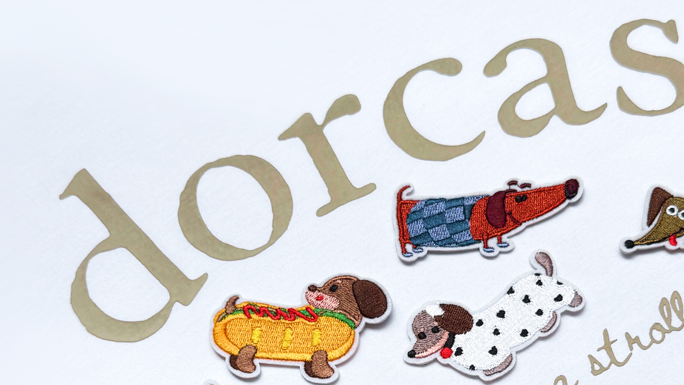 Stickers of dogs with 'dorcas' branding on a light background
